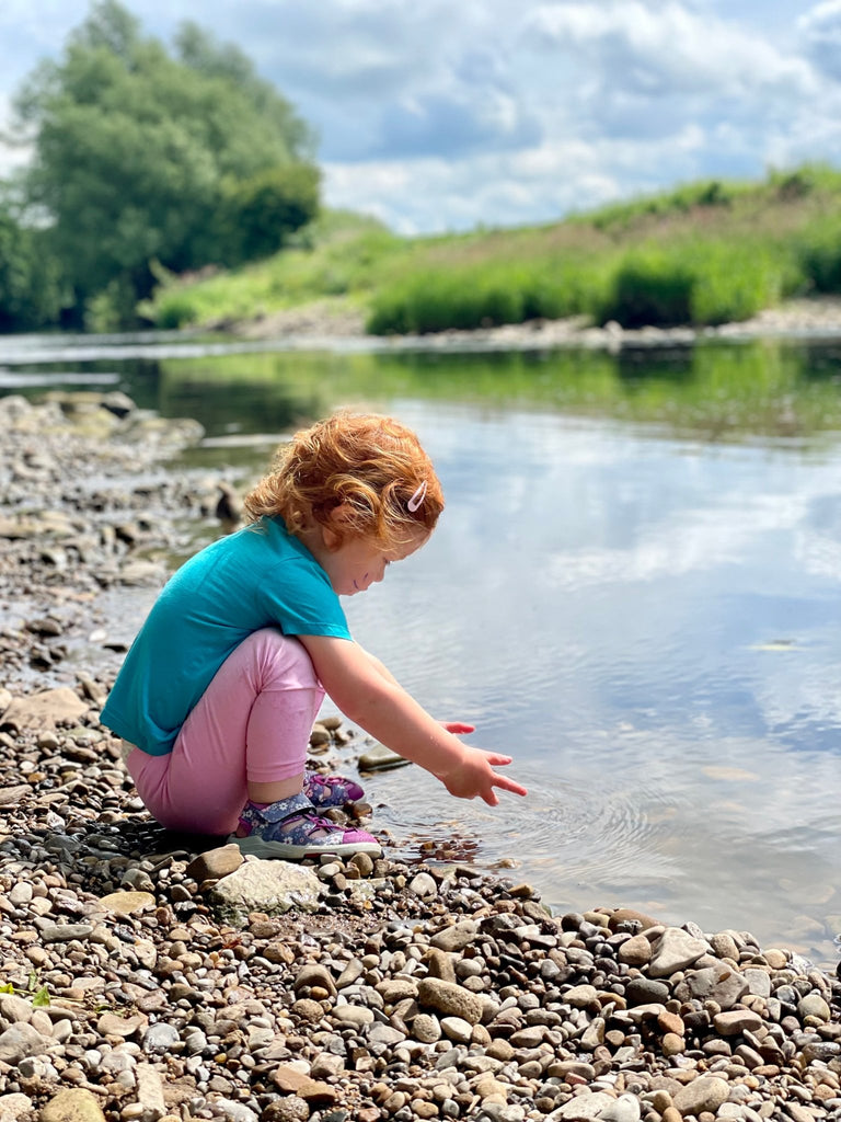 Child playing by a river