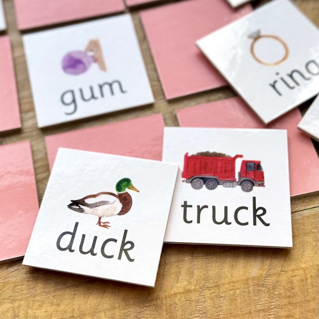 Duck and truck rhyming pairs tiles on wooden table