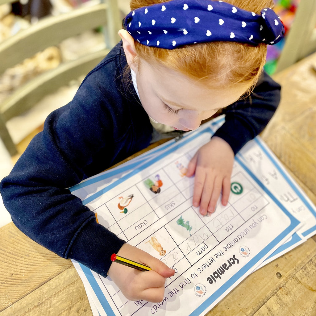 Child playing scramble from the Printable Phonics Games Phase 2